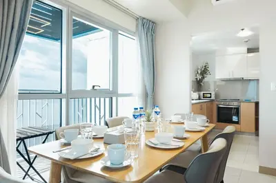 a dining room with a table and chairs and a large window at Elegant 3 Bedroom unit with Ocean View near Okada in Manila