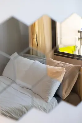 a pile of white pillows sitting on a bed at Peaceful & Calm 1BR Studio l Near MOA, SMX & NAIA in Manila