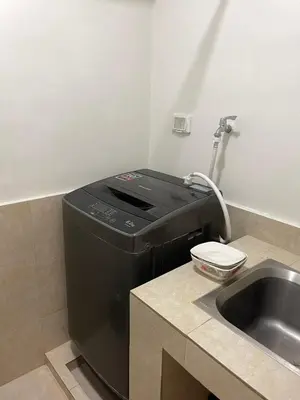 a black printer sitting next to a sink at Condotels by Tribecca Private in Manila