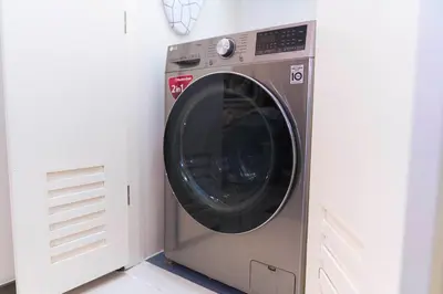 a washing machine in a corner of a room at Casa Celestine Staycation in Manila