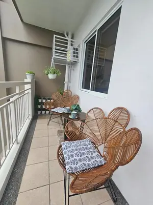 a patio with three chairs and a table on a balcony at Casa Celestine Staycation in Manila