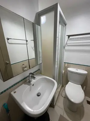 a bathroom with a sink and a toilet and a mirror at Antel Spa Residences 2509 in Manila