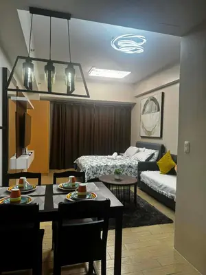 a living room with a dining table and a couch at Cluster 4 10f in Manila