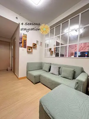 a living room with a couch in a room at Vacation Home MOLUAN in Manila
