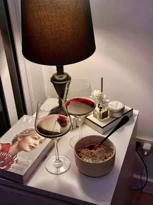 two glasses of wine and a bowl of food on a table at Vacation Home MOLUAN in Manila