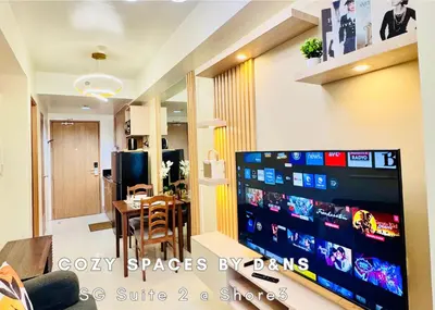 a living room with a table and a television at SM MOA Near NAIA Airports 1 Bedroom with balcony SG Suite 2 at Shore 3 in Manila