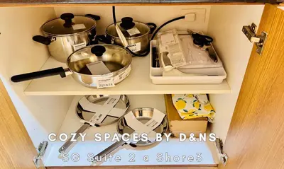 a cabinet filled with pots and pans on a shelf at SM MOA Near NAIA Airports 1 Bedroom with balcony SG Suite 2 at Shore 3 in Manila