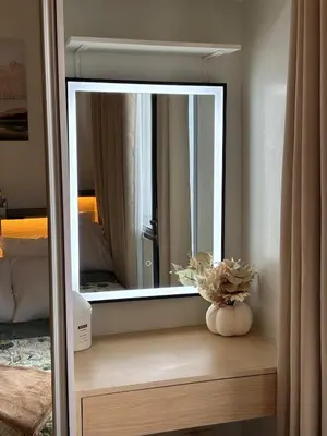 a mirror sitting on a wooden shelf in a room at R Cabin - Shore Residences in Manila