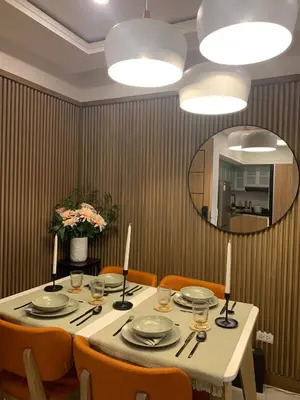 a dining room table with chairs and a large mirror at Vacation in Cupang Muntinlupa in Manila