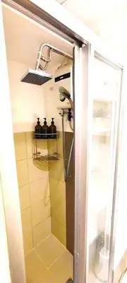 a shower with a glass door in a bathroom at Move In Condo in Taguig Fully Furnished in Manila