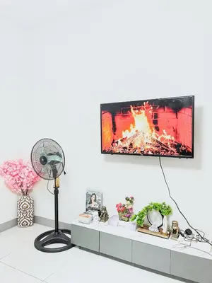 a living room with a tv on a wall at Cozy Family and Group-Friendly Private 2 Bedroom with Coffee Bar and Fast Wifi at S Residences Mall of Asia in Manila
