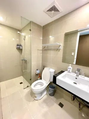a bathroom with a toilet and a sink and a shower at La Venezia Executive Home, 3 Bedroom, 7 adults Maximum plus Kids in Manila