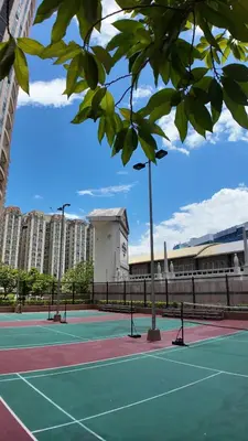 two tennis courts with buildings in the background at La Venezia Executive Home, 3 Bedroom, 7 adults Maximum plus Kids in Manila