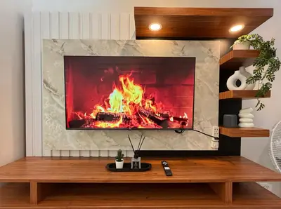 a fireplace in a living room with a fire at Near NAIA Mediterranean Cozy Home with Netflix in Manila