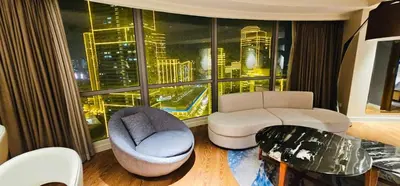 a living room with a view of a city at Hotel Residences - Novotel Suites Manila at Acqua in Manila