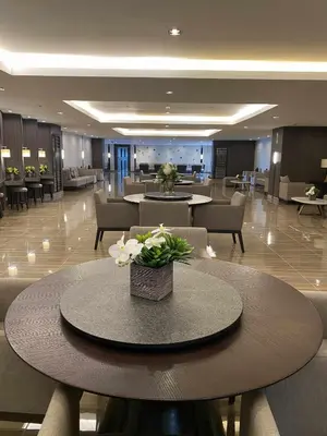 a lobby with a table with flowers on it at Air Residences 28F Balcony WiFi Netflix in Manila