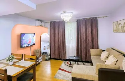 a living room with a couch and a table at Bright & Airy Loft Cambridge Village Charm in Cainta