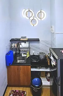a kitchen with a sink and a stove at Bright & Airy Loft Cambridge Village Charm in Cainta