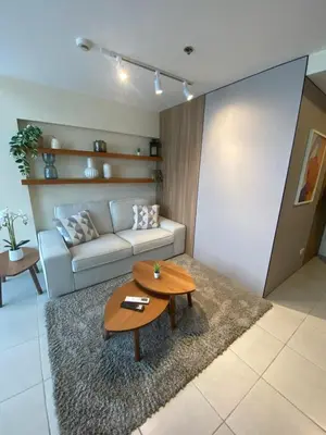 a living room with a couch and a table at EDSA Heights Unit 3405 Cozy One Bedroom Penthouse Unit in Manila