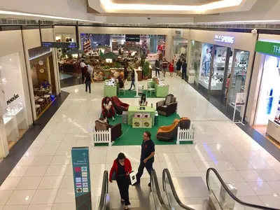 a group of people walking through a shopping mall at Free Parking at Gramercy with Big TV and Fast WiFi in Manila