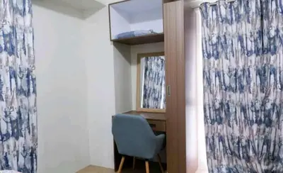 a room with a blue chair and a window at 5A Southwing in Manila