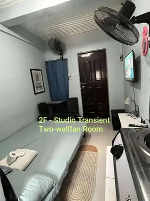 a small room with a bed and a sink at Studio in the 2nd floor Transient Room with two wallfan in Manila