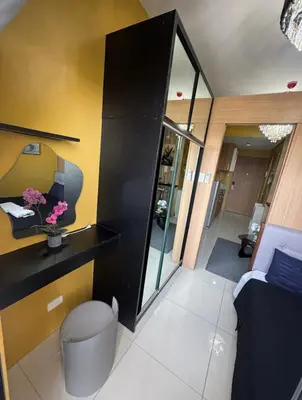 a living room with a black and yellow wall at David's Cozy Home in Manila