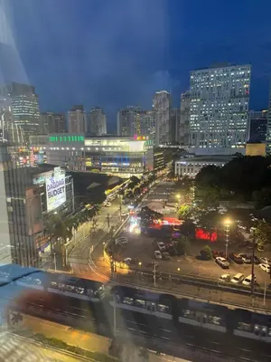 a city at night with a busy street with cars at Faith Studio Cubao in Manila