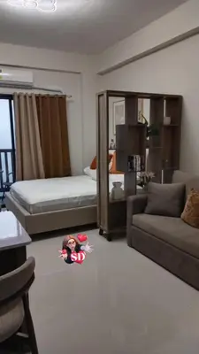 a bedroom with a bed and a doll on the floor at Condotels Near Sucat Skyway in Manila