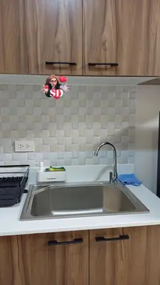 a stainless steel sink in a kitchen with at Condotels Near Sucat Skyway in Manila