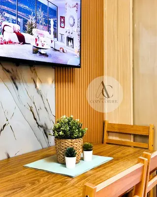a dining room table with two potted plants on it at Sea Residence 1BR unit 5 to 10 min walk to MOA by Angels Cozy Corner in Manila
