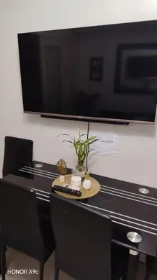 a desk with a tv and a remote control on it at Moa SEA RESIDENCE condotel in Manila