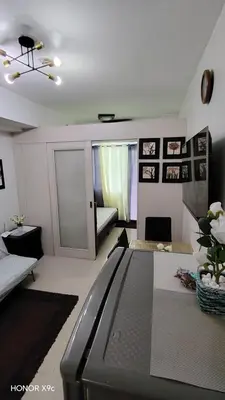 a living room with a tv and a couch at Moa SEA RESIDENCE condotel in Manila