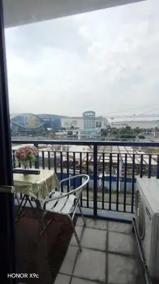 a balcony with a table and a view of the water at Moa SEA RESIDENCE condotel in Manila