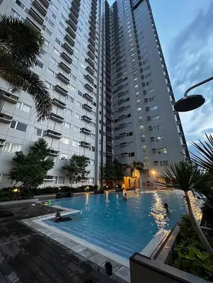 a large apartment building with a large swimming pool at Leo's Master bedroom in Manila