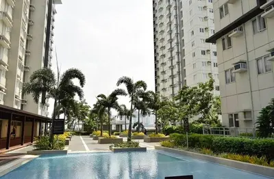 a swimming pool in the middle of two buildings at Leo's Master bedroom in Manila