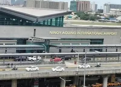 a building with cars on a highway in front at One Palm Tree Villas-Hyuna Place Across Naia T3 Manila in Manila