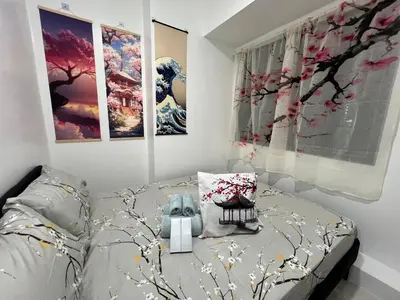 a bedroom with a bed and paintings on the wall at Japan Theme Near Estancia Shaw MRT Kapitolyo Shangrila Mall Megamall Elements in Manila