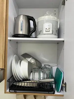 a kitchen shelf with dishes and a tea kettle at Japan Theme Near Estancia Shaw MRT Kapitolyo Shangrila Mall Megamall Elements in Manila