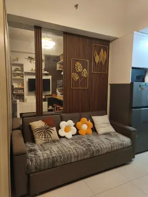 a couch with stuffed animals on it in a living room at MOA Staycation in Manila