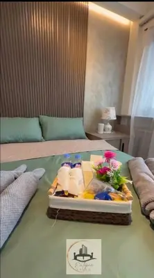 a tray of towels and towels on a bed at Eutopia Vista- 2 Bedroom Condo in SMDC Bloom in Manila