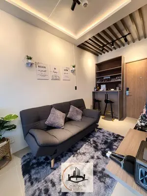 a living room with a couch and a table at Eutopia Vista- 2 Bedroom Condo in SMDC Bloom in Manila