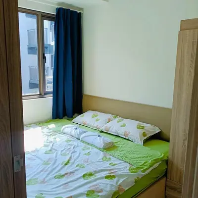 a bed in a room with a window at S Residences by Seren View-main in Manila