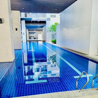 a swimming pool with blue tile in a building at S Residences by Seren View-main in Manila