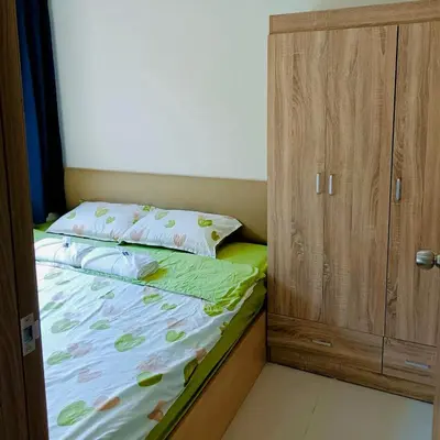 a small bedroom with a bed and a cabinet at S Residences by Seren View-main in Manila