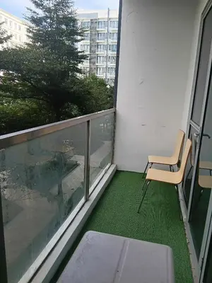 a balcony with a chair and a view of a building at Cluster 4 5D in Manila