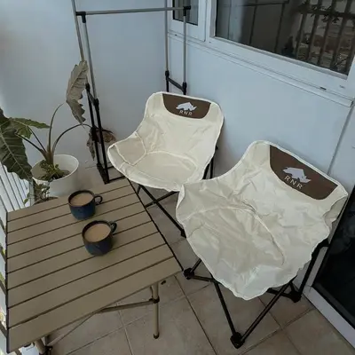 two chairs sitting next to a table and a window at Whimsy Stay in Manila