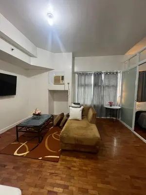 a living room with a couch and a table at Robinson's Place Residences, in Manila