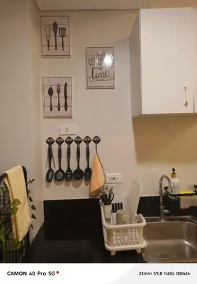 a kitchen with a sink and utensils on the wall at K&C Suite in Trece Martires