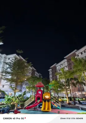 a playground with a slide in a park at night at K&C Suite in Trece Martires